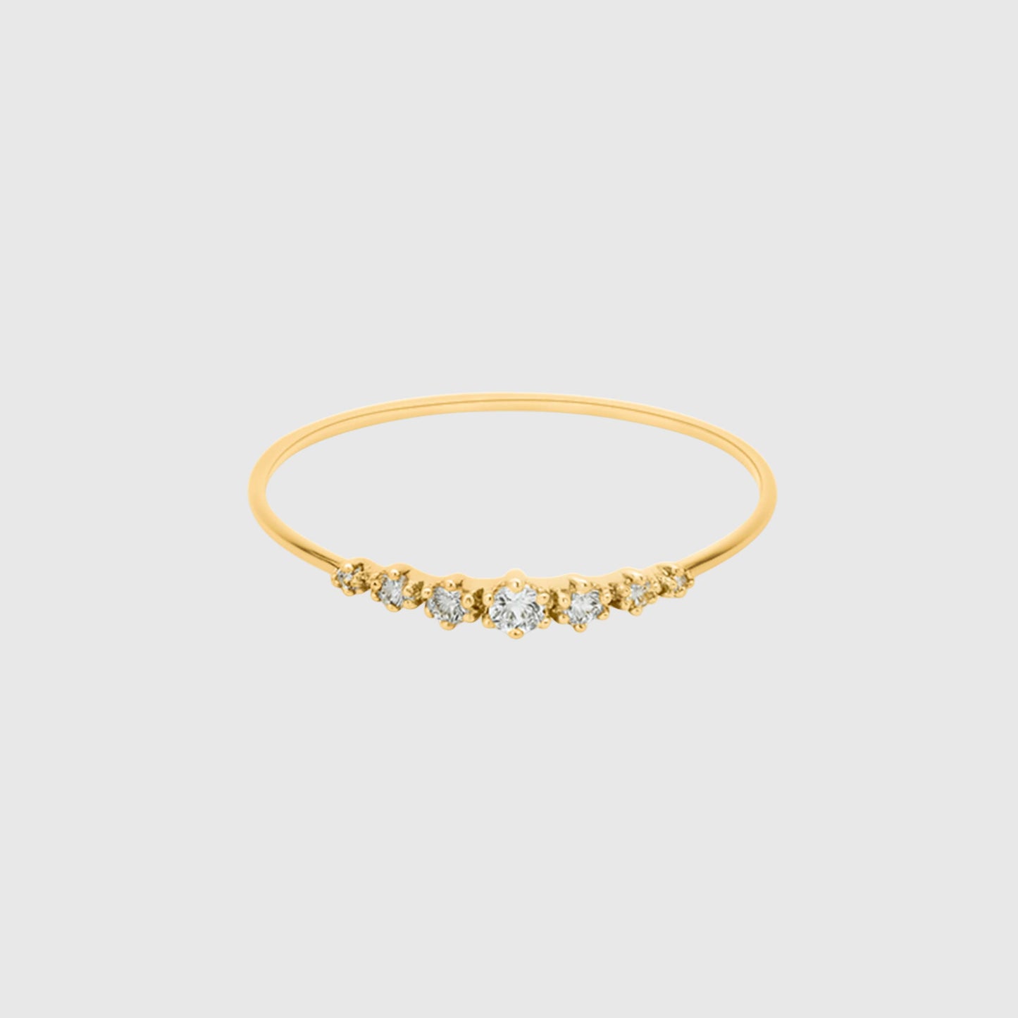 Gold bracelet with small diamonds on a light gray background