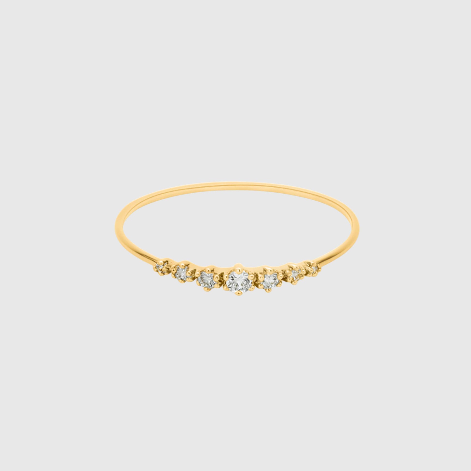 Gold bracelet with small diamonds on a light gray background