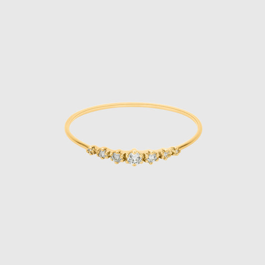 Gold bracelet with small diamonds on a light gray background