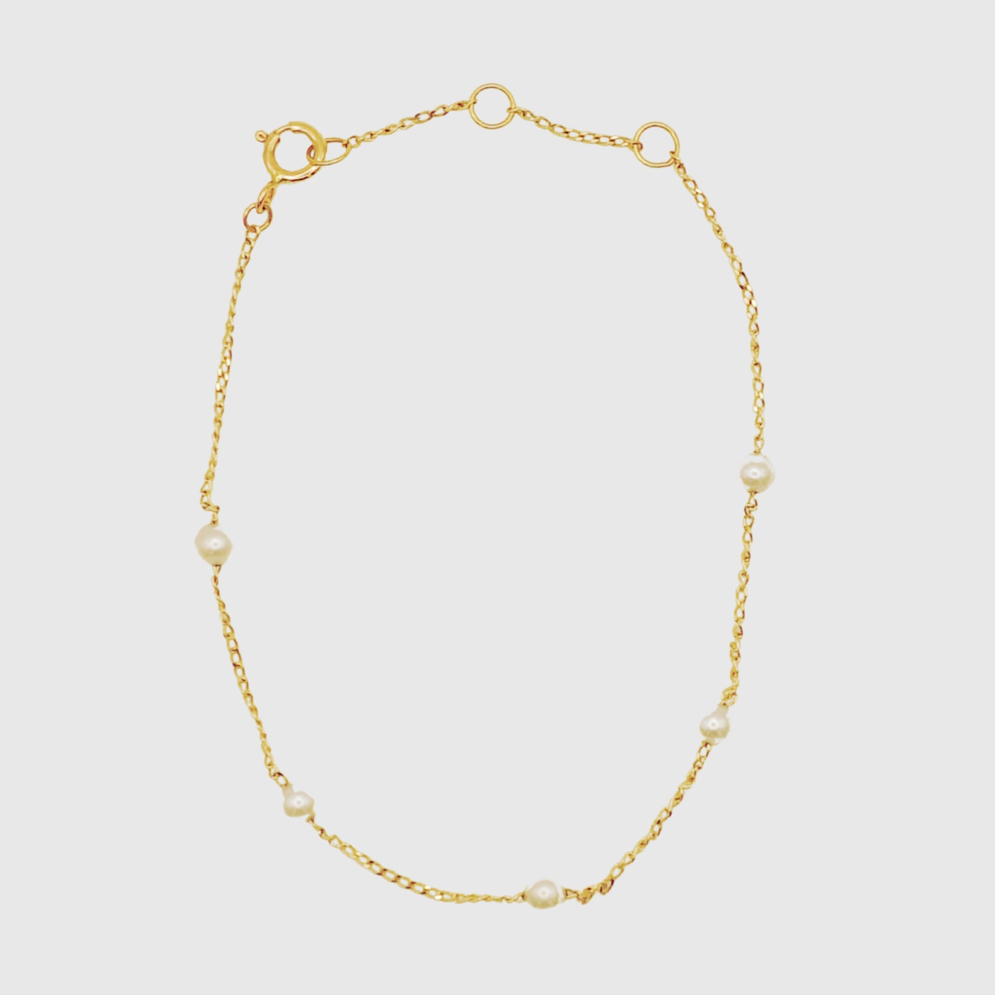 Solid gold bracelet with small pearls 