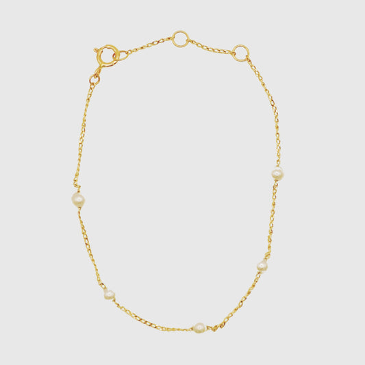 Solid gold bracelet with small pearls 